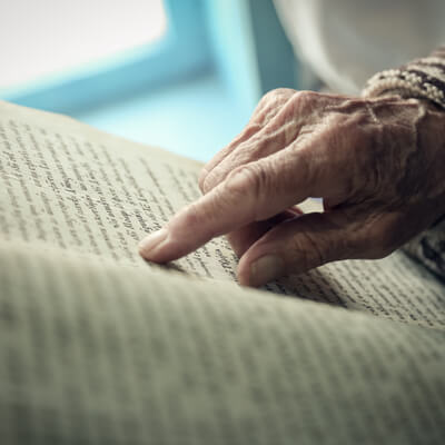 A finger touching an open book